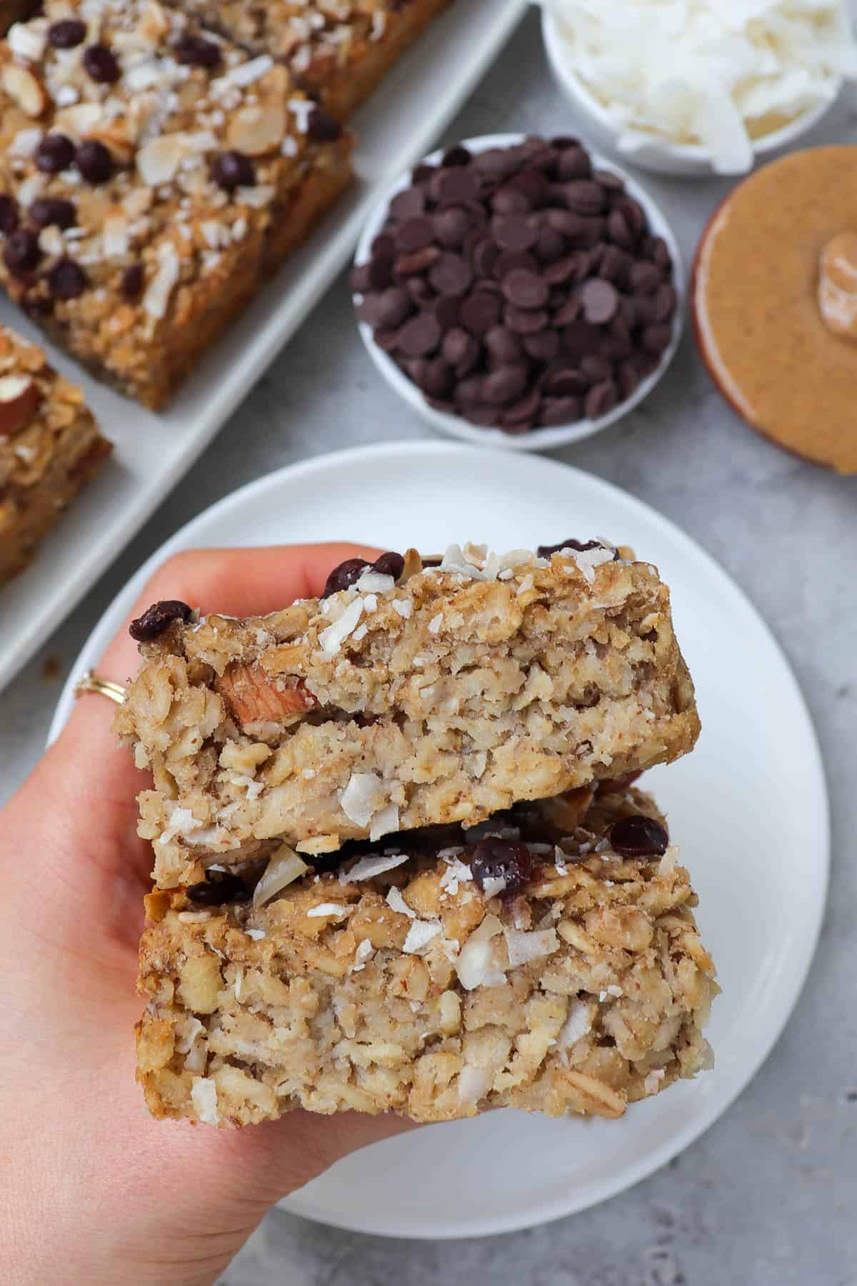 Holding oatmeal bars in hand for side view.