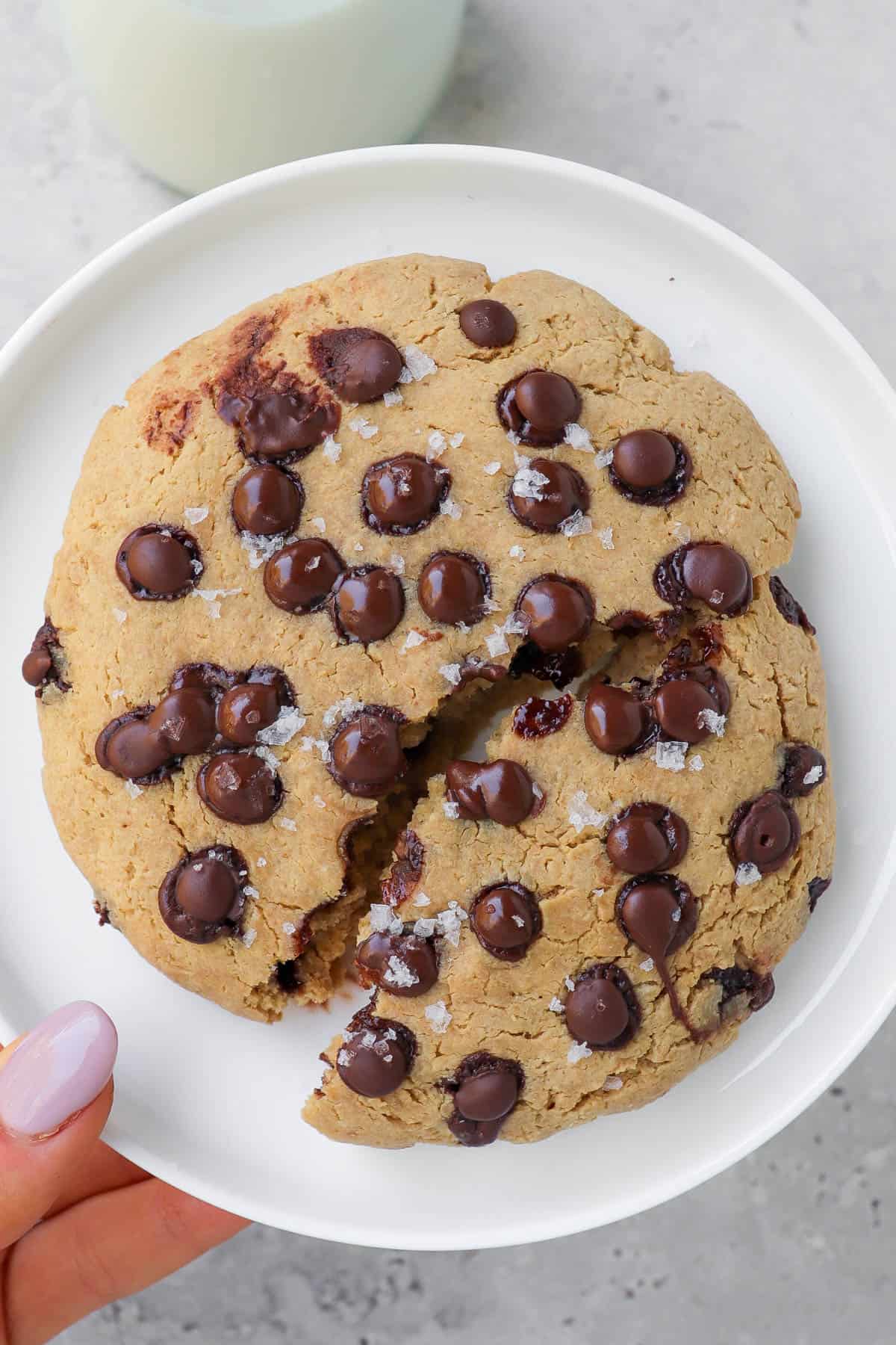 Cookie broken in half on a plate.