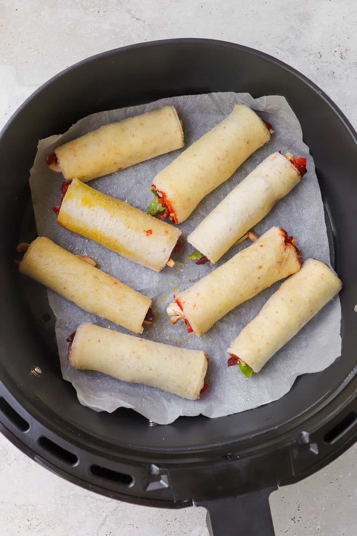 Pizza rolls in the air fryer basket.