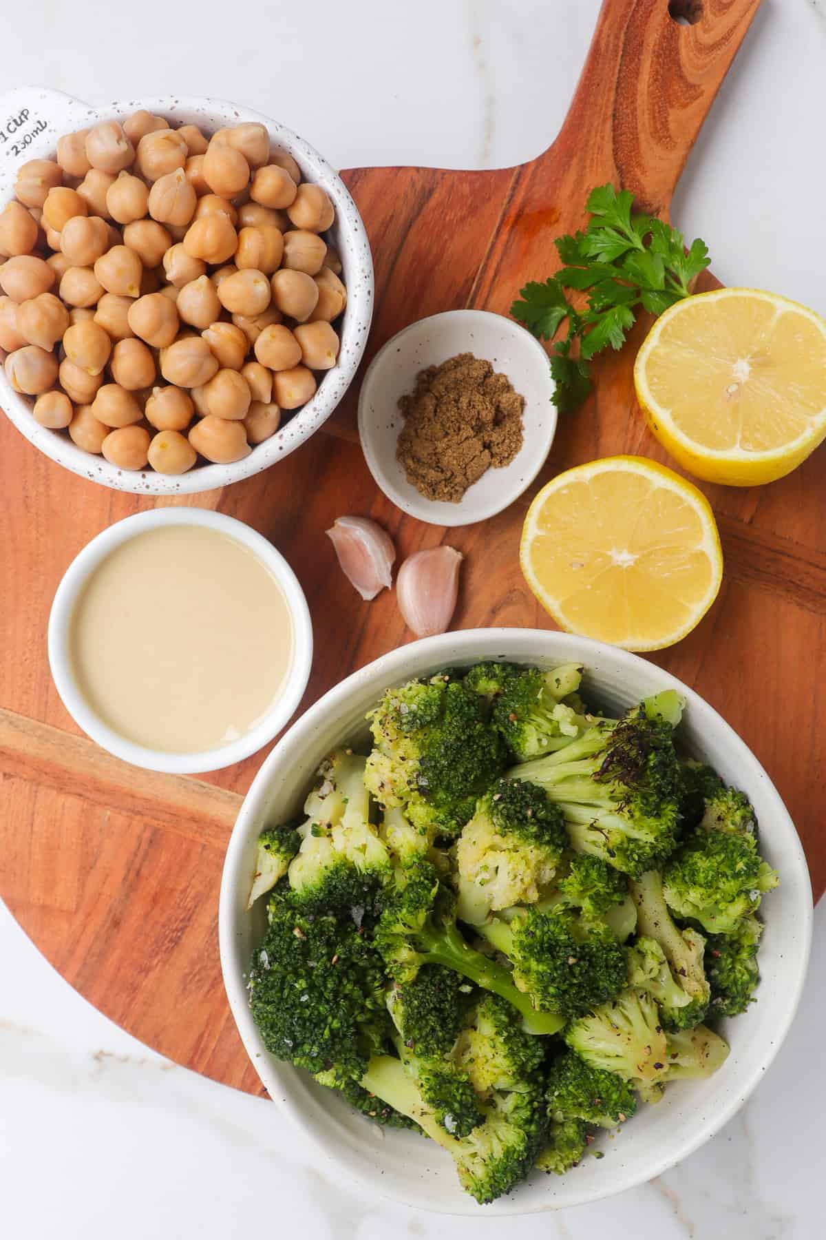 Ingredients needed to make broccoli hummus shown.