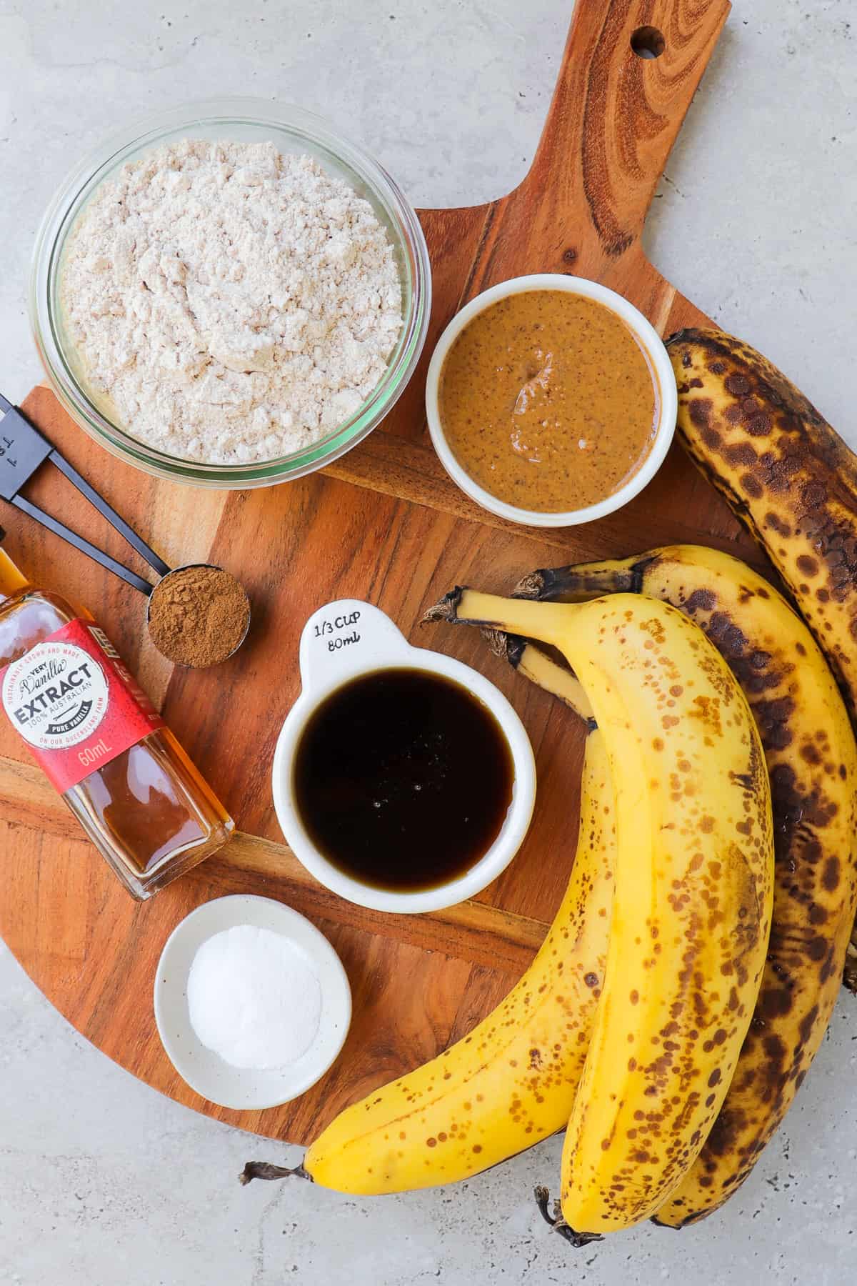 Ingredients on wooden board to make vegan banana bread.