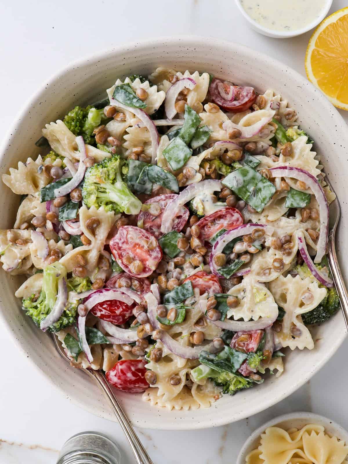 Pasta salad in a bowl with forks.