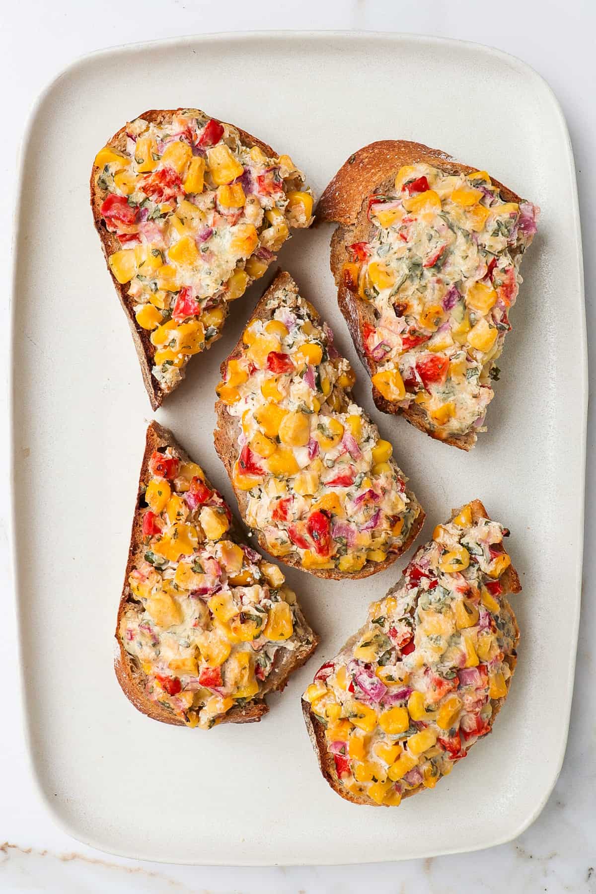 Cut up corn toasts on a platter.