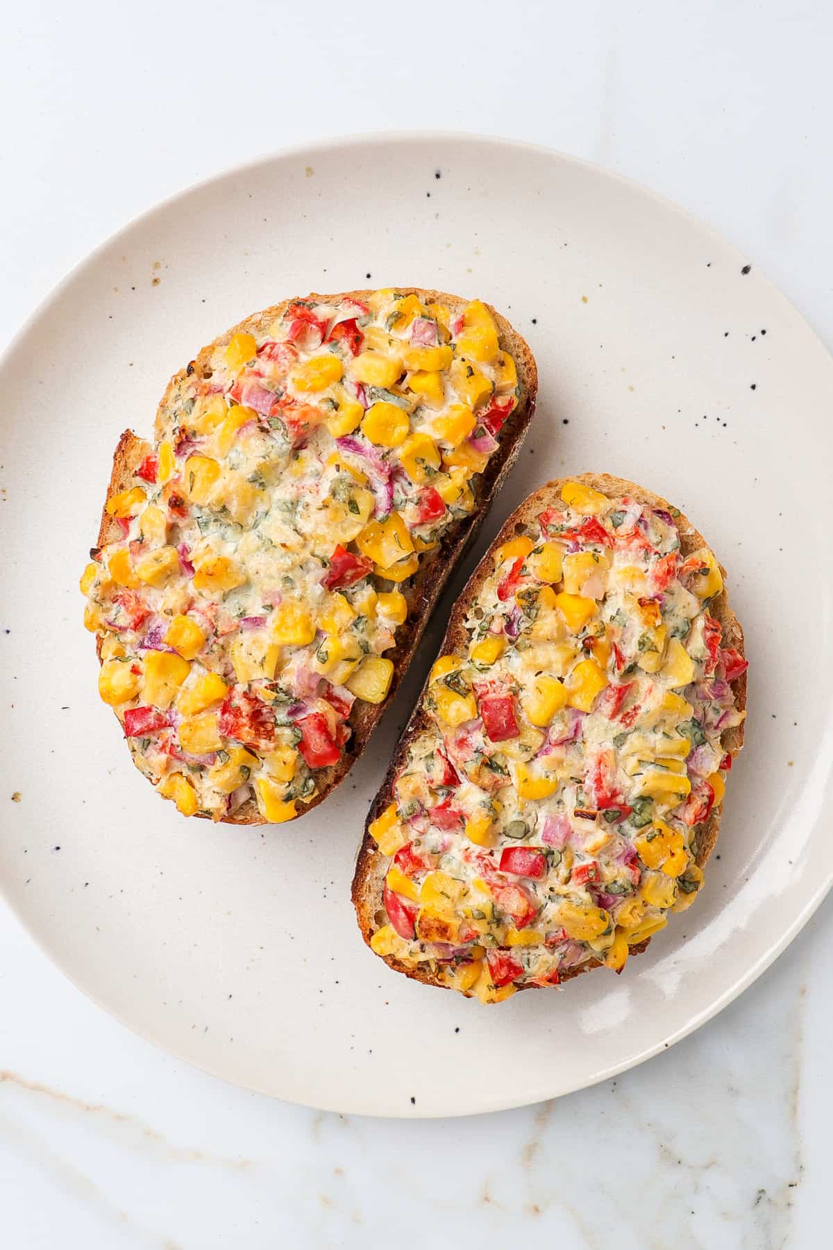 Two corn toasts on a plate.