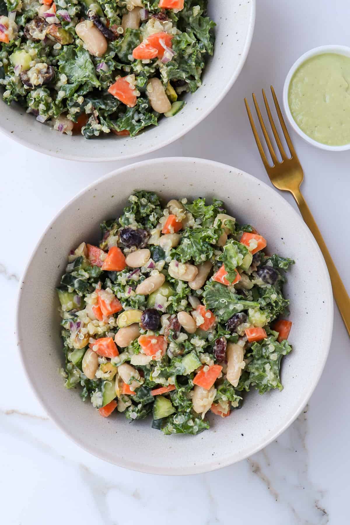 Kale and white bean salad served in bowls.