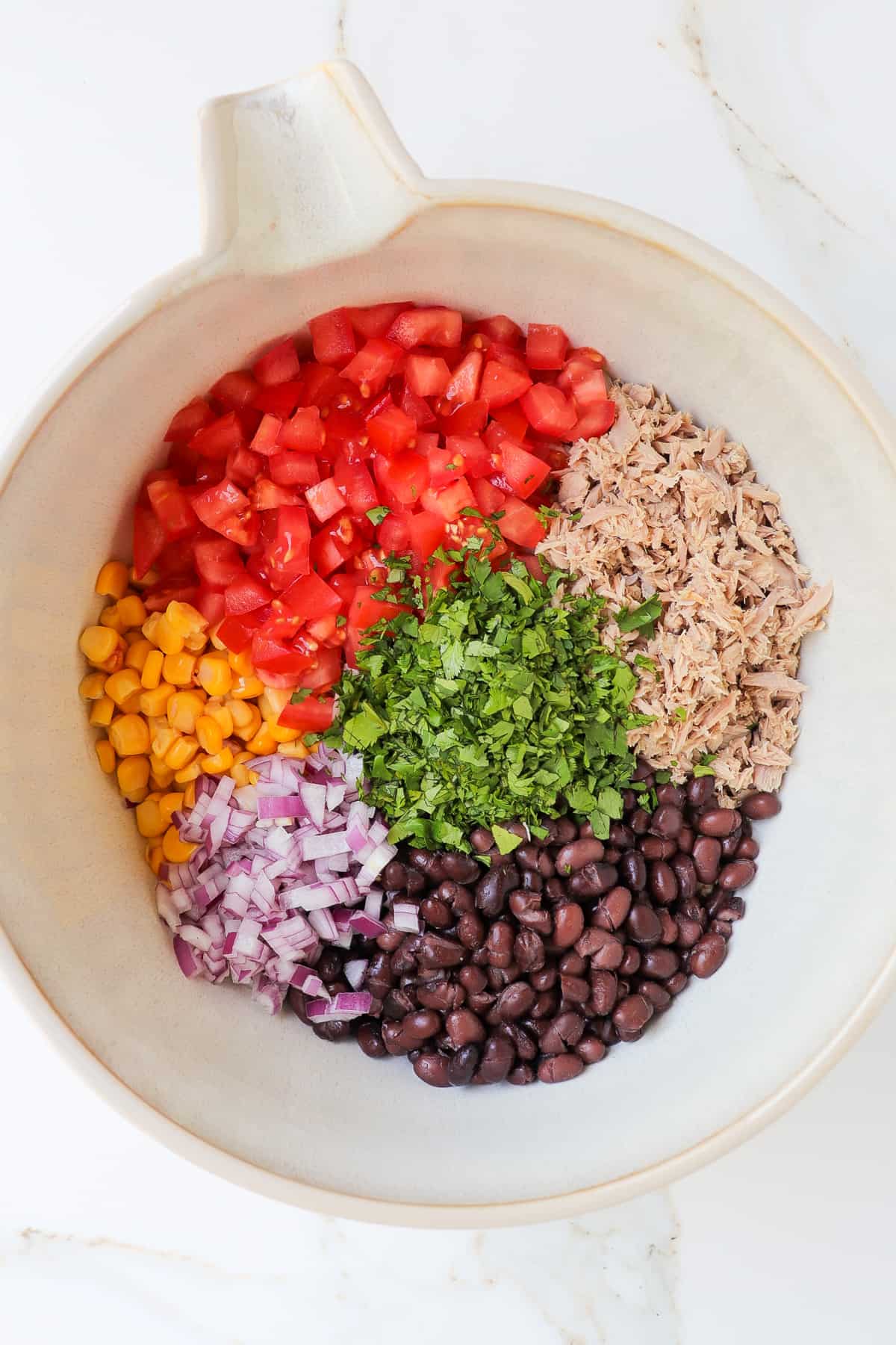 Salad ingredients in a mixing bowl.