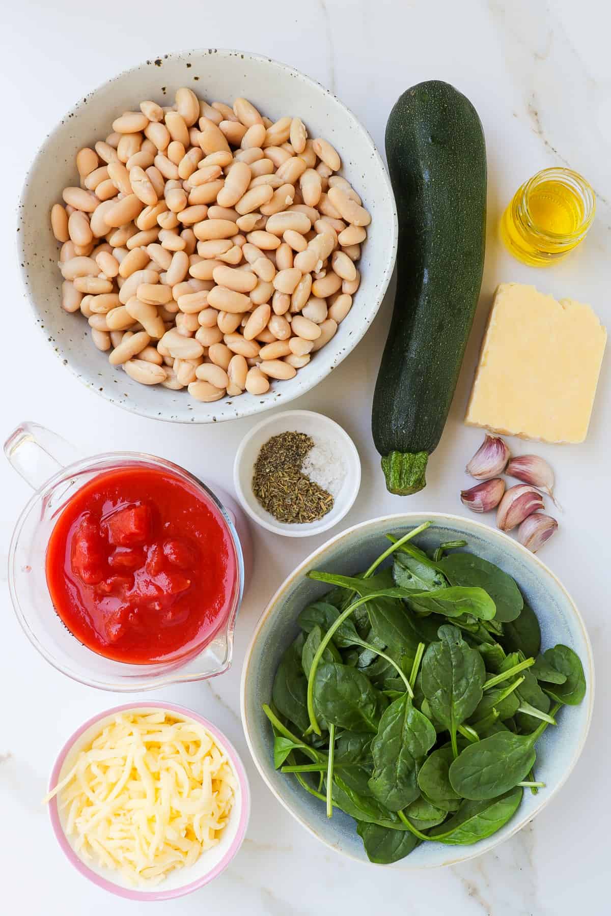 Ingredients shown to make the cheesy baked white beans.