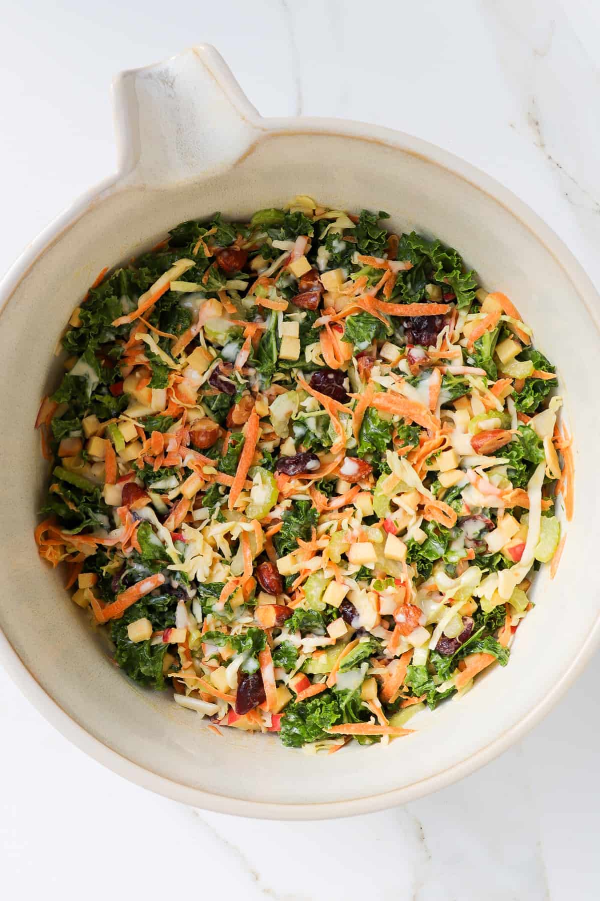 Crunchy kale salad in a large mixing bowl.