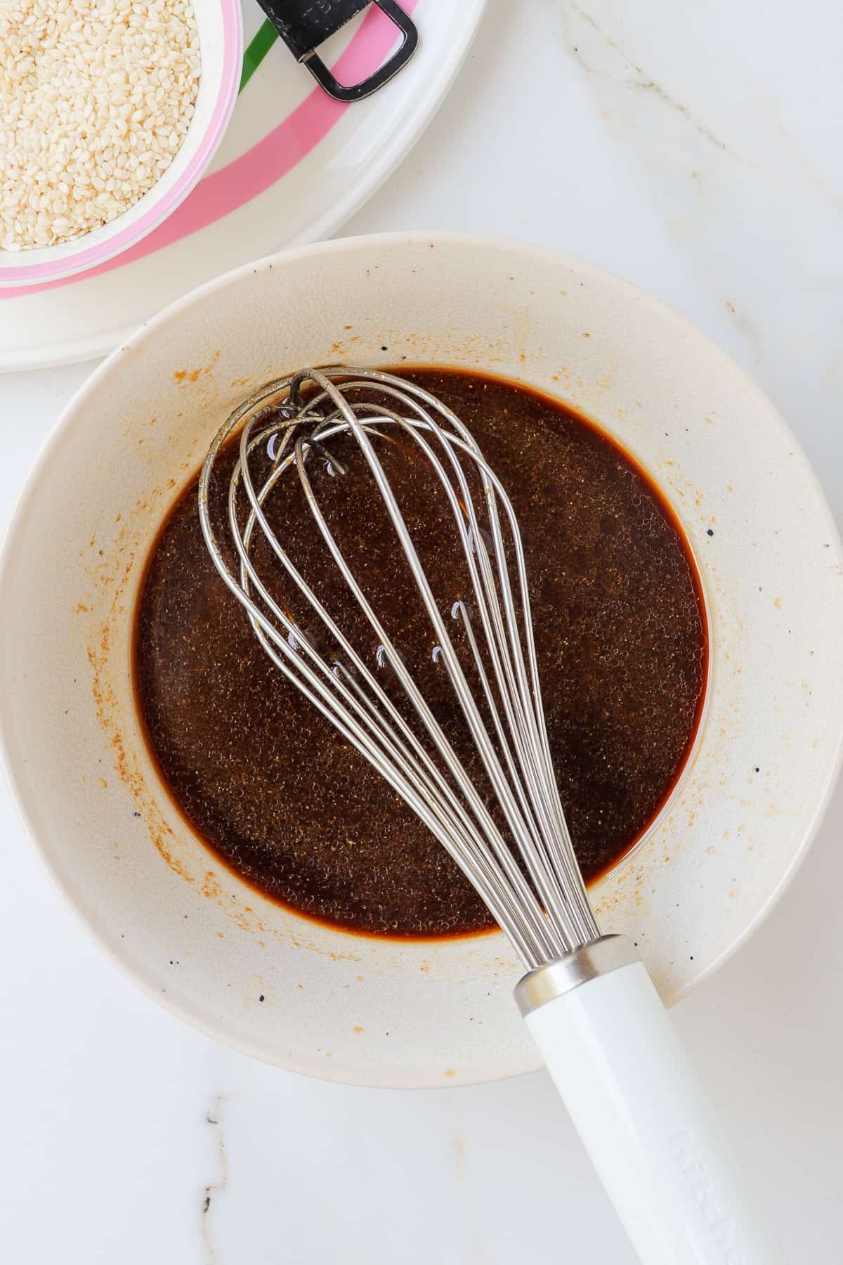 Teriyaki sauce being whisked in a bowl.
