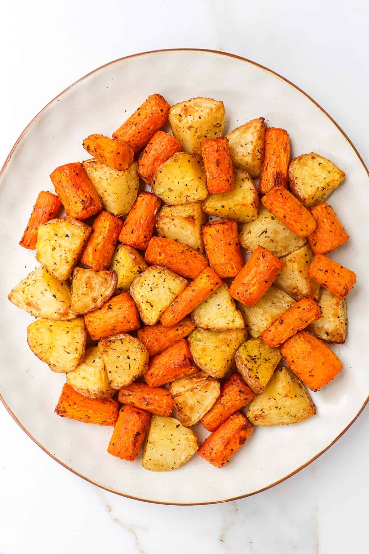 Air fryer potatoes and carrots on a plate.