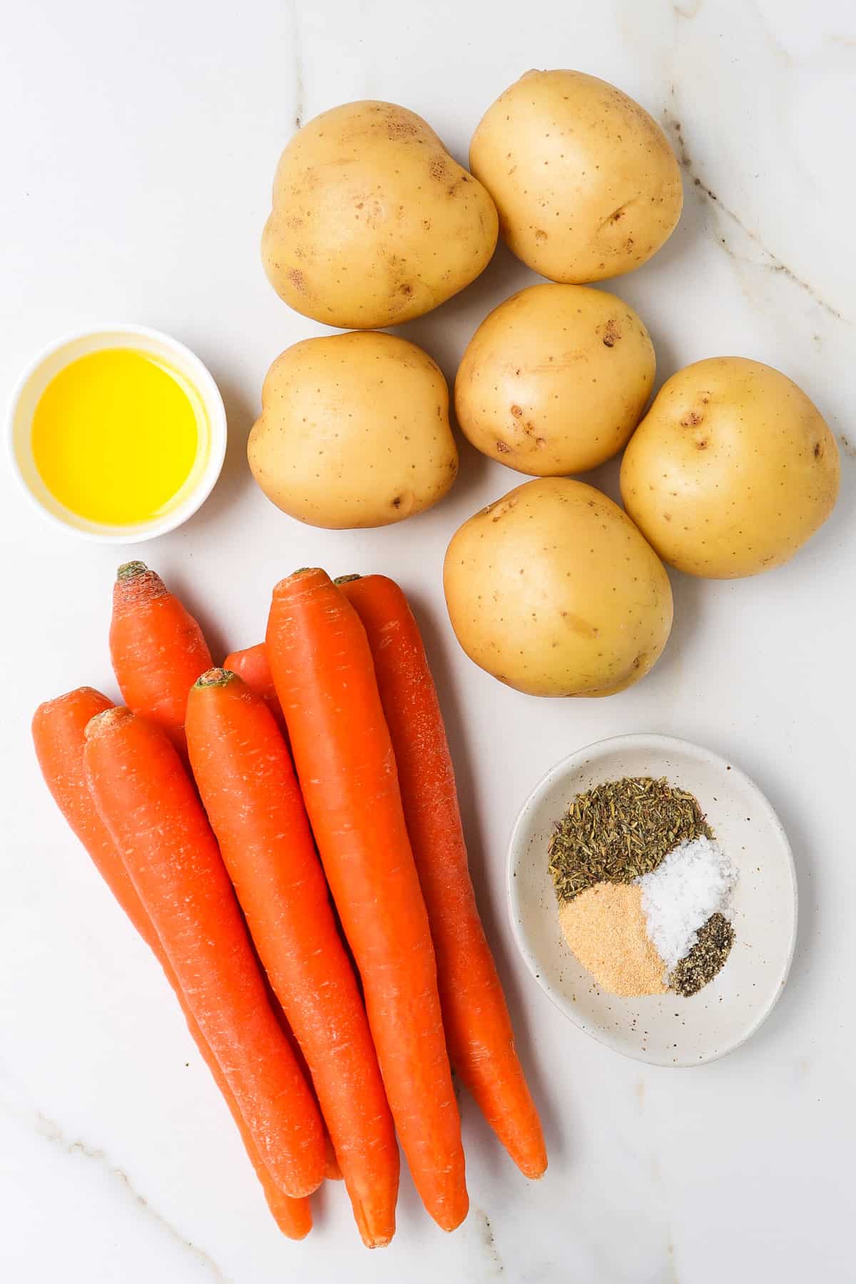 Ingredients needed to make air fried potatoes and carrots.
