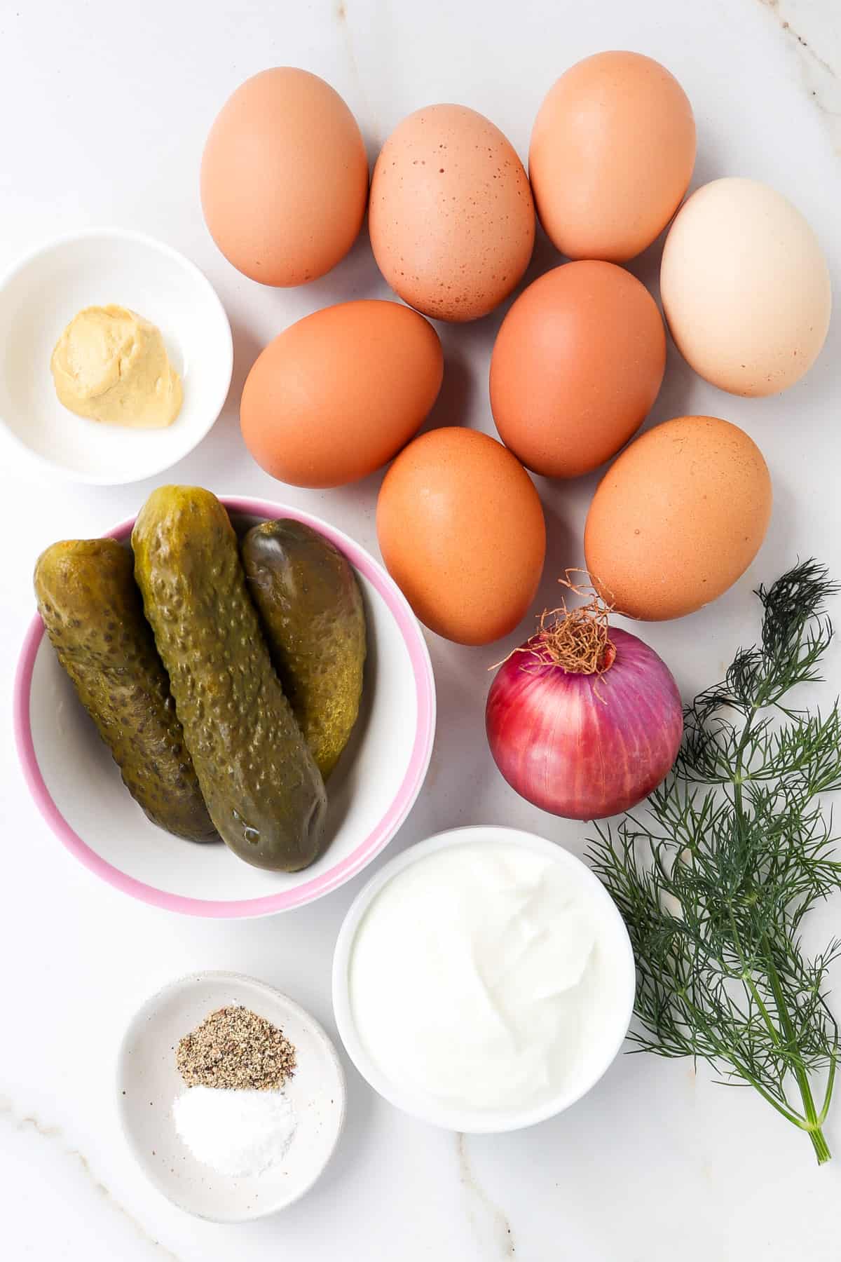 Ingredients shown to make egg salad with pickles.