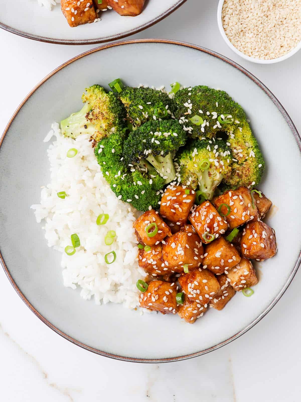 Honey garlic tofu in a bowl with roasted broccoli and rice.