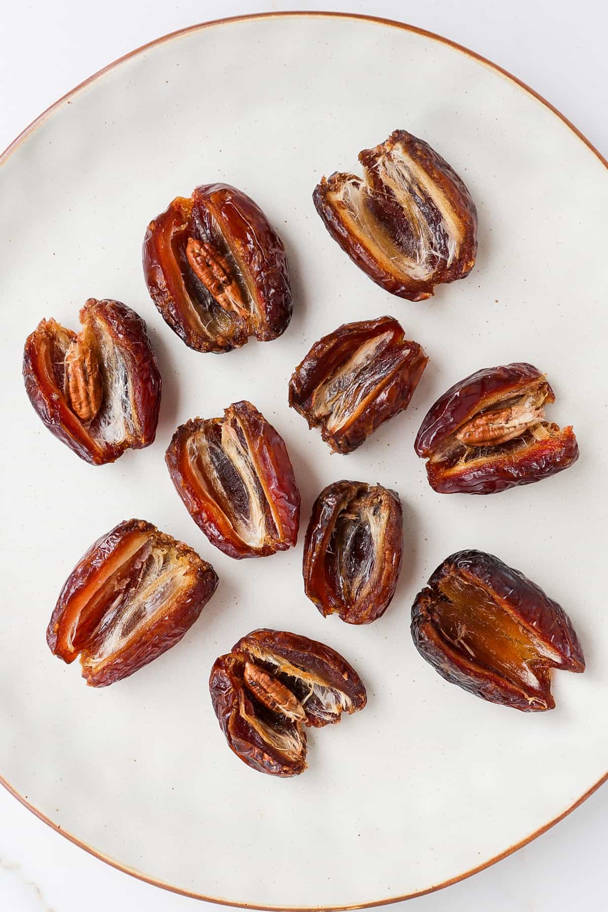 Medjool dates cut open with pits removed.