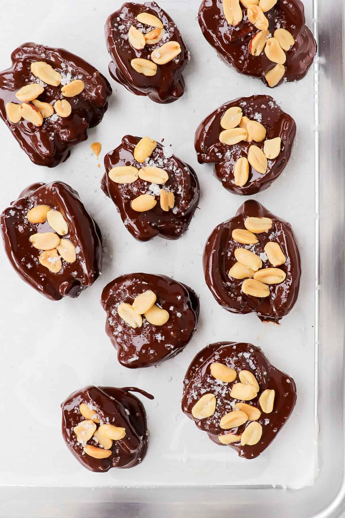 Melted chocolate covered dates with peanuts.
