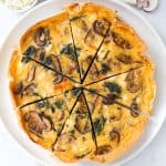 Spinach mushroom quiche on a plate.