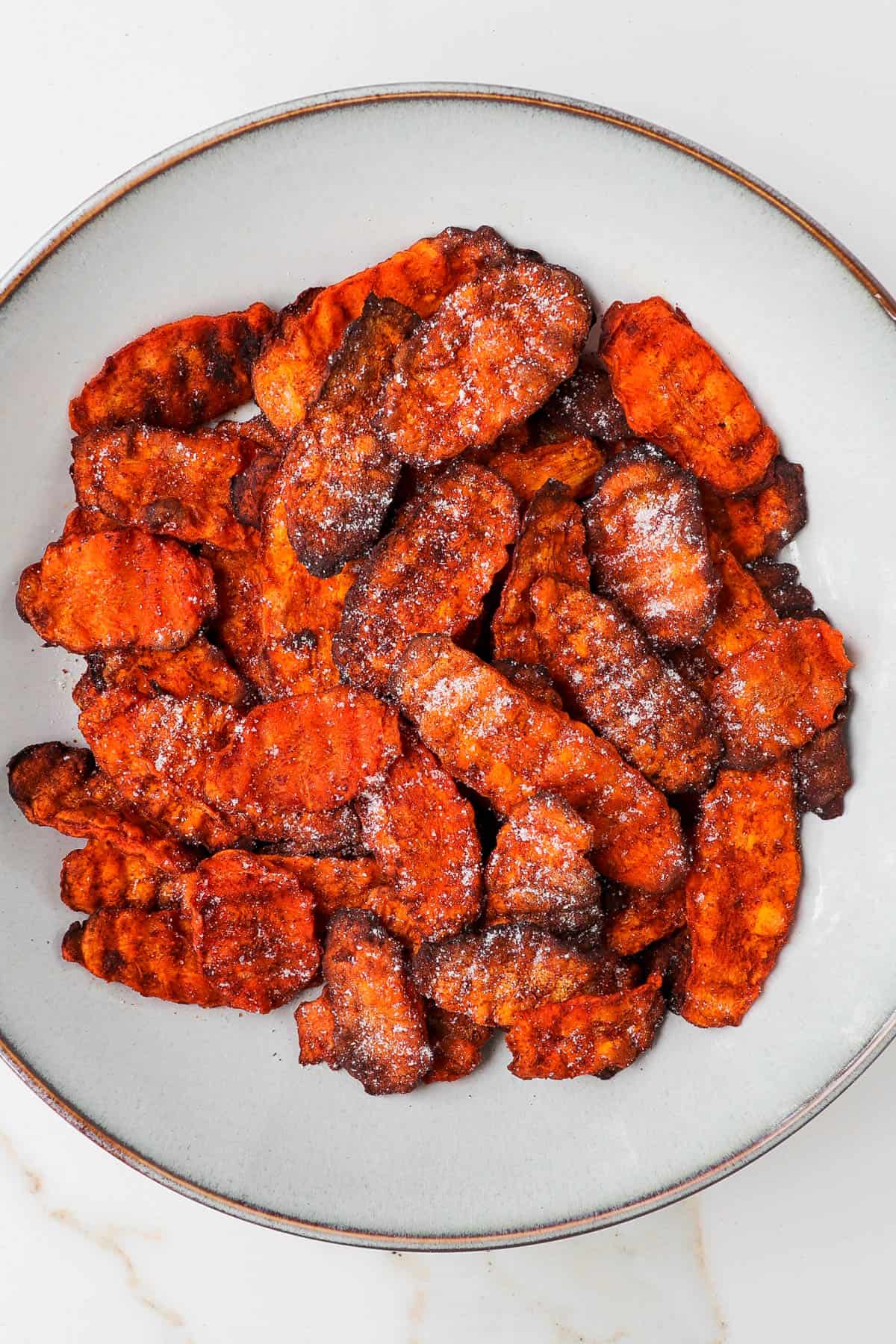 Air fryer carrot chips in a bowl.