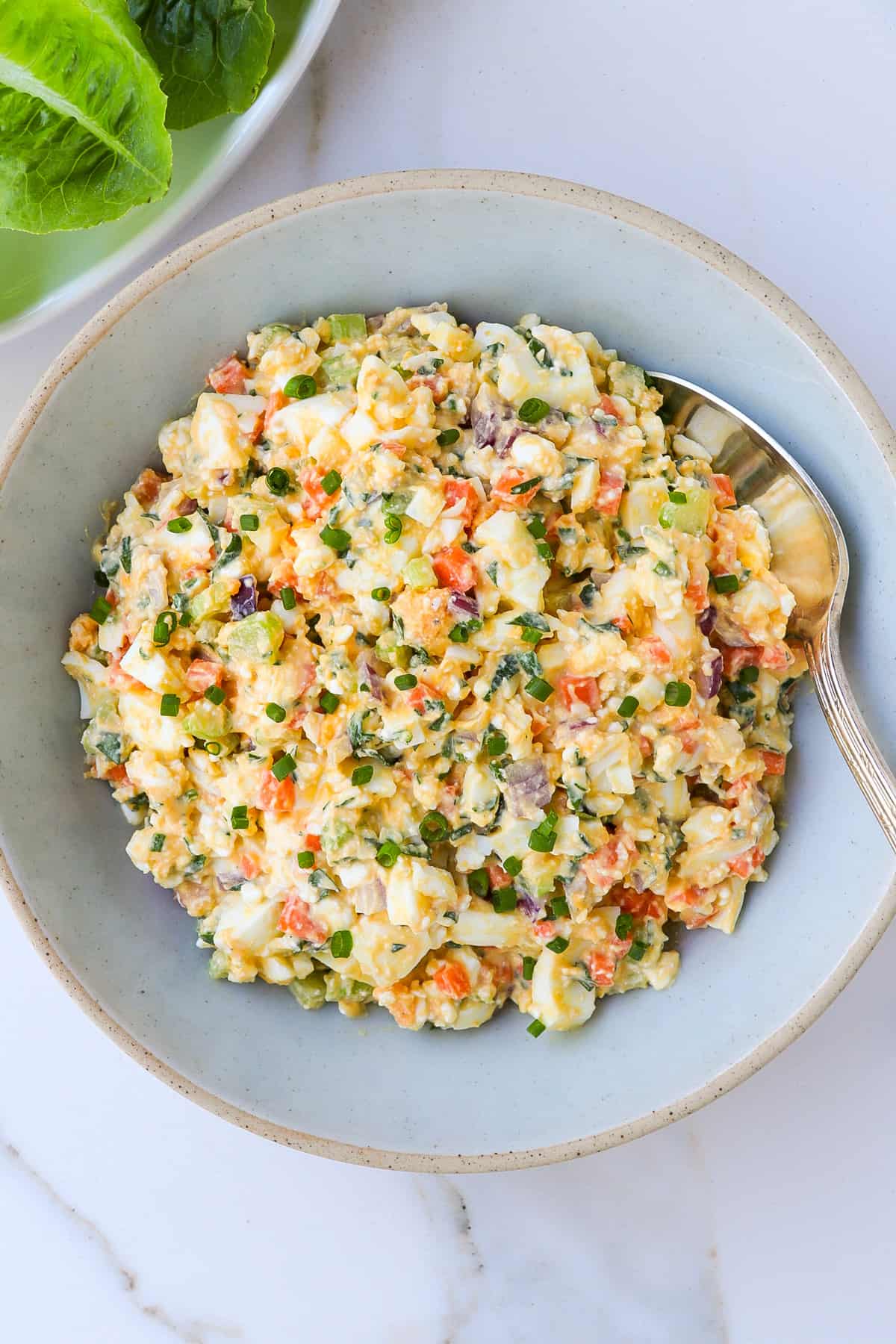 Egg salad in a bowl with a spoon.
