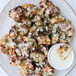 Sumac cauliflower with tahini sauce drizzled and served on the side.