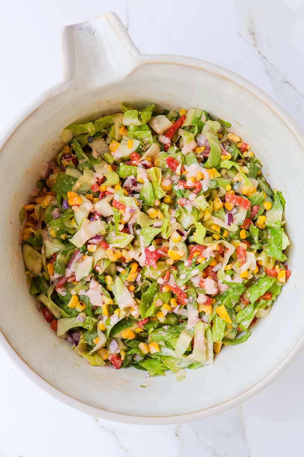 Grilled corn salad in a mixing bowl.