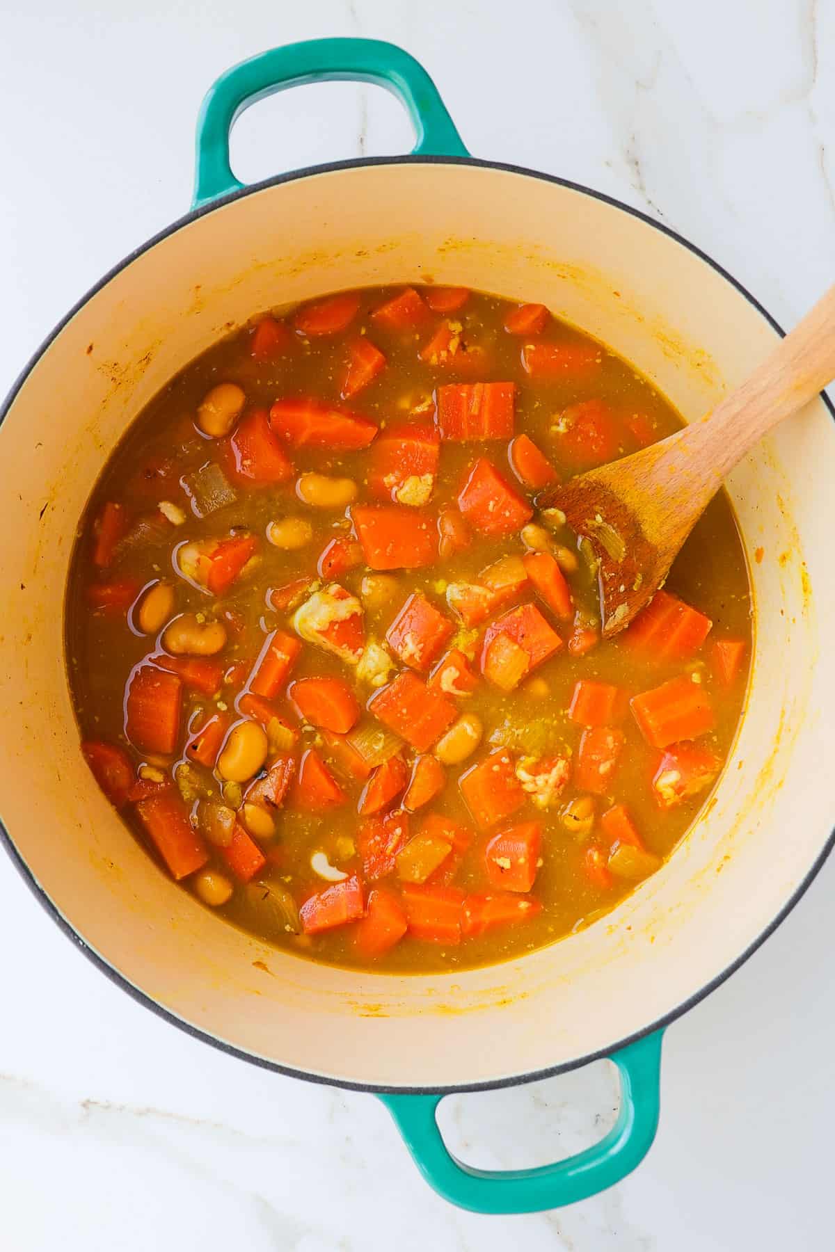 Soup in a pot with vegetables softened just before blending.