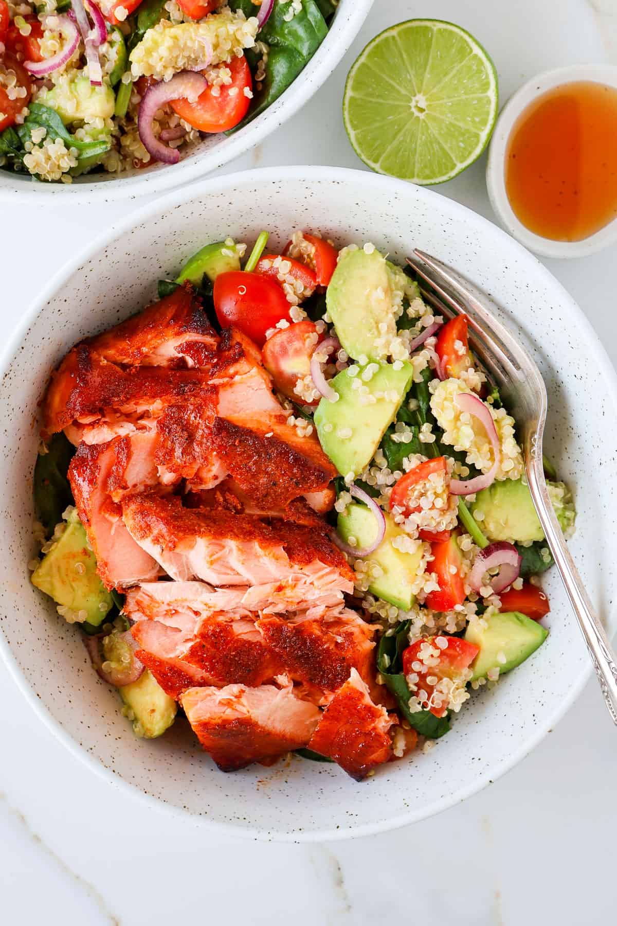 Paprika salmon filet in a bowl with a salad.