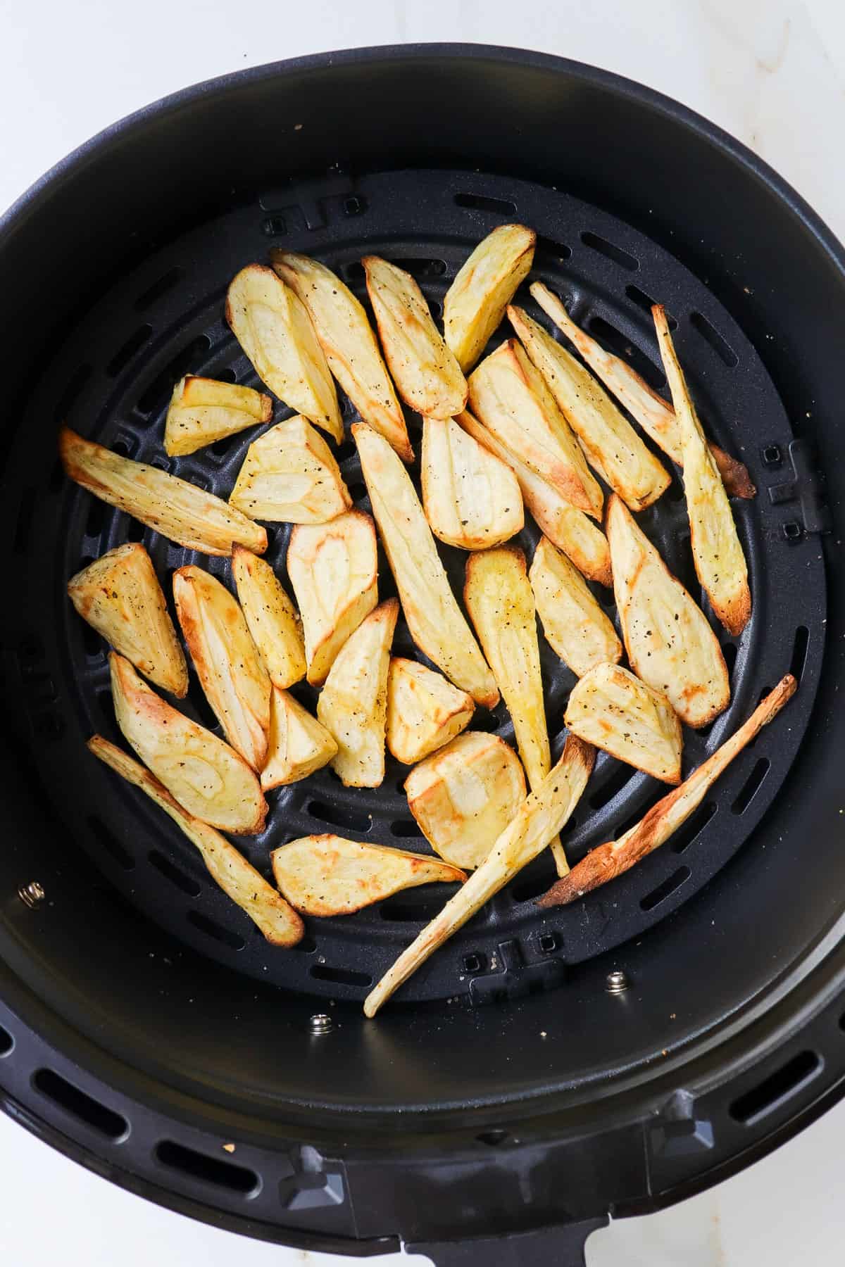 Air fried parsnips in basket.