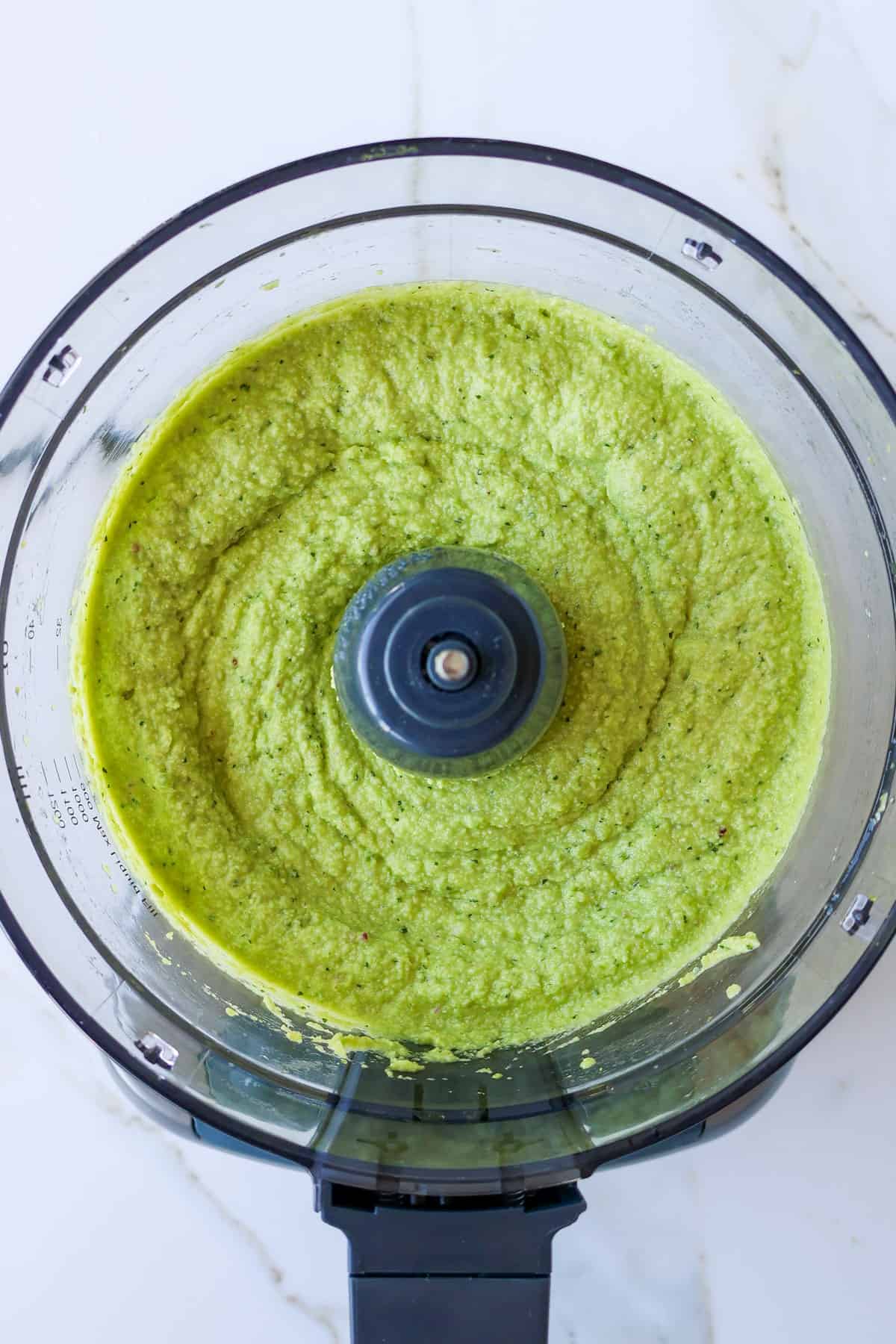 Blended guacamole in a food processor.
