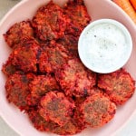 Carrot and beetroot fritters in a bowl.
