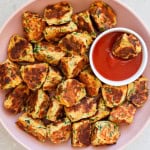 Ricotta veggie fritters in a bowl with ketchup.