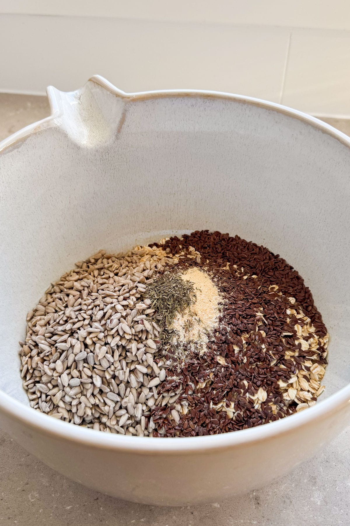 Oats, seeds and seasonings in a bowl.