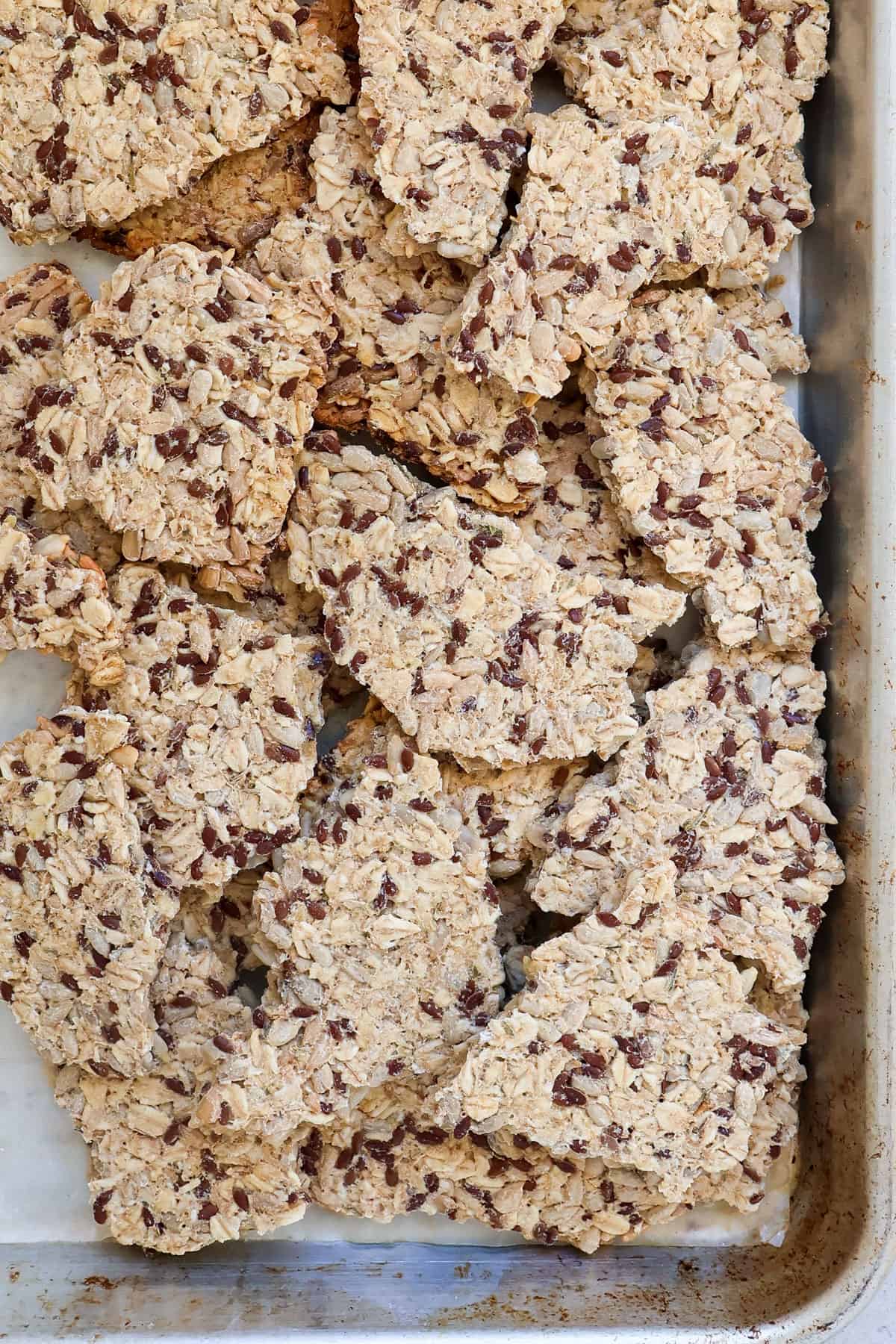 Broken up crackers on baking tray.