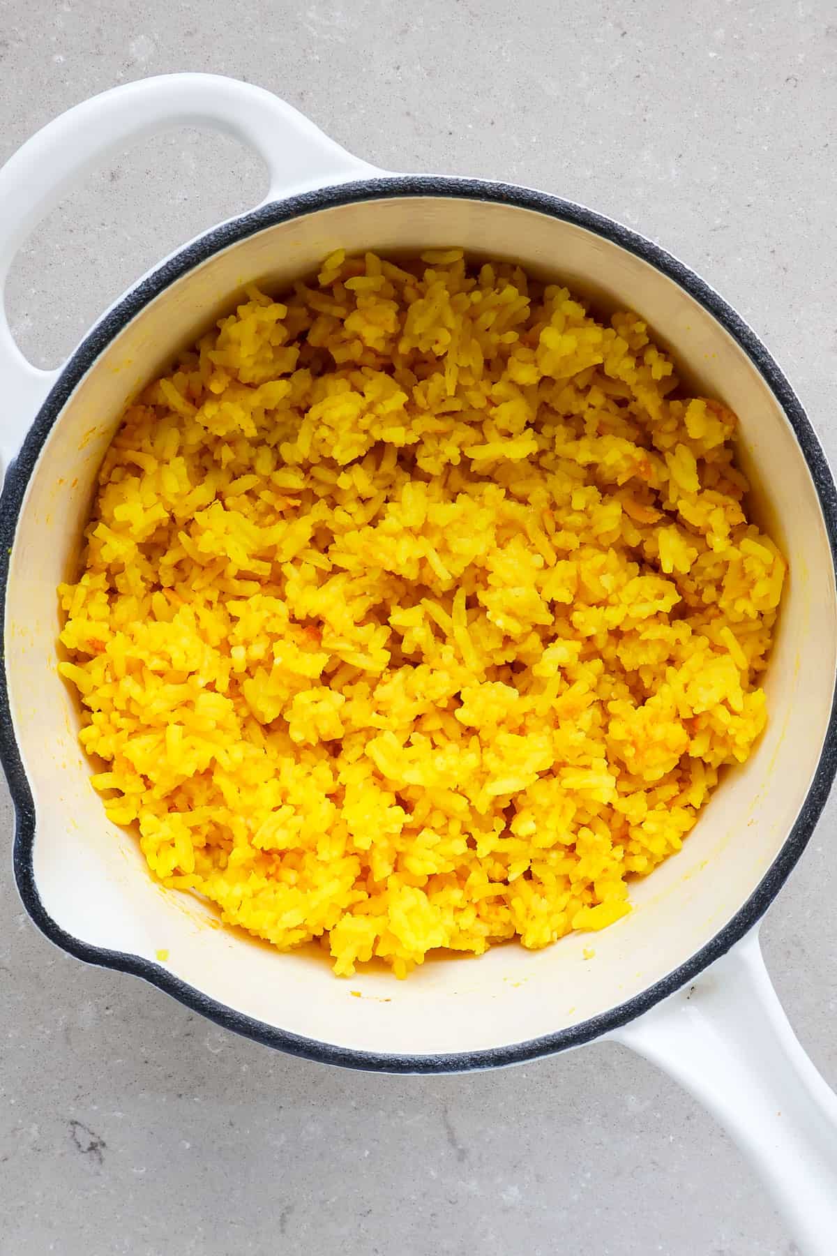Golden turmeric rice in a pot.