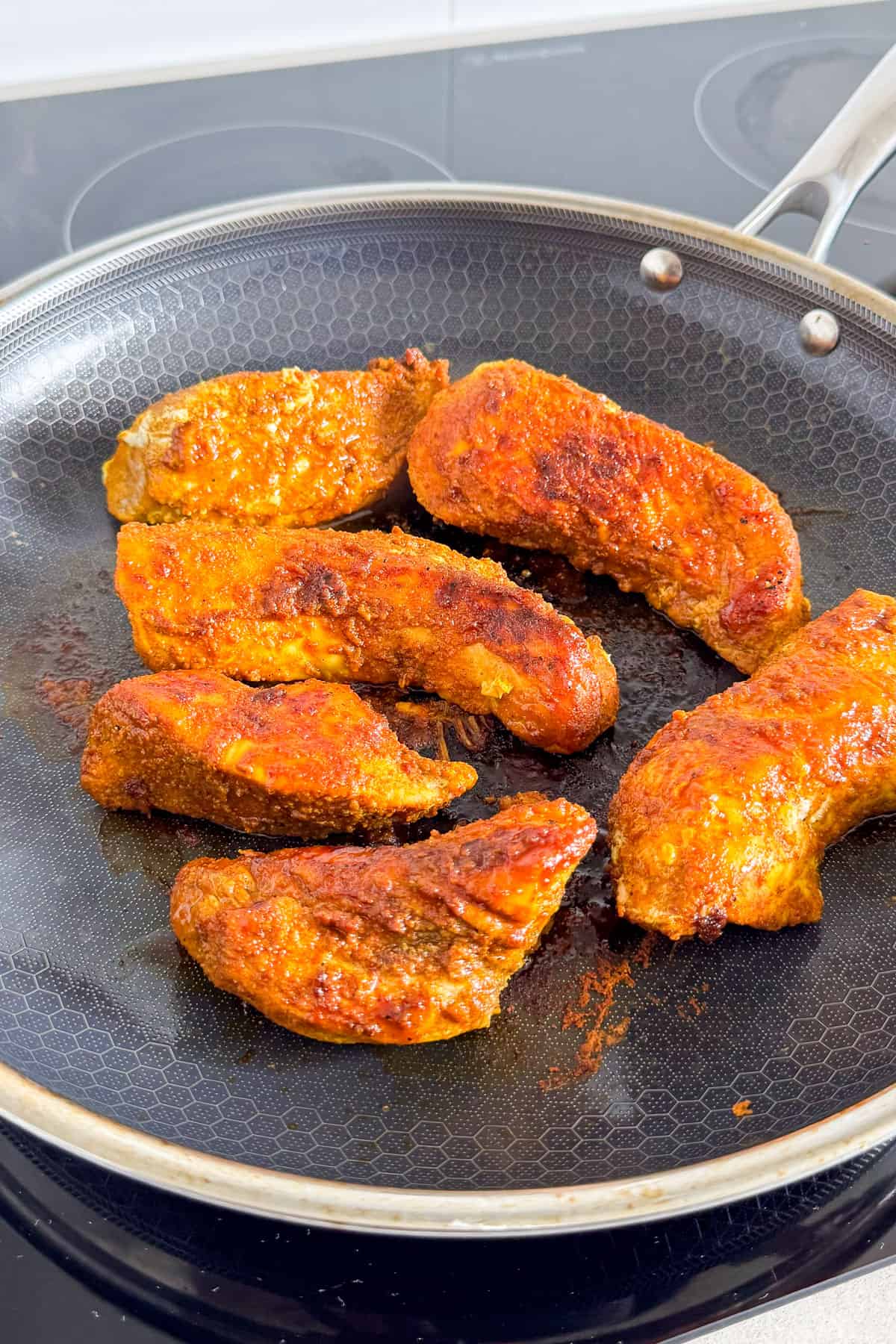 Cooked chicken in skillet.
