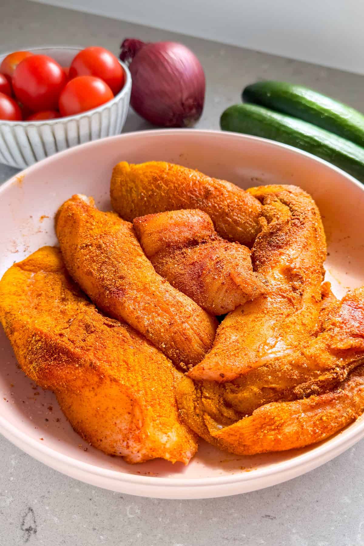 Marinated chicken in a bowl.