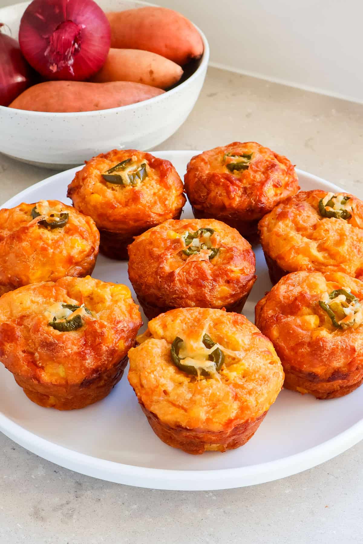 Sweet potato and corn muffins on a plate.