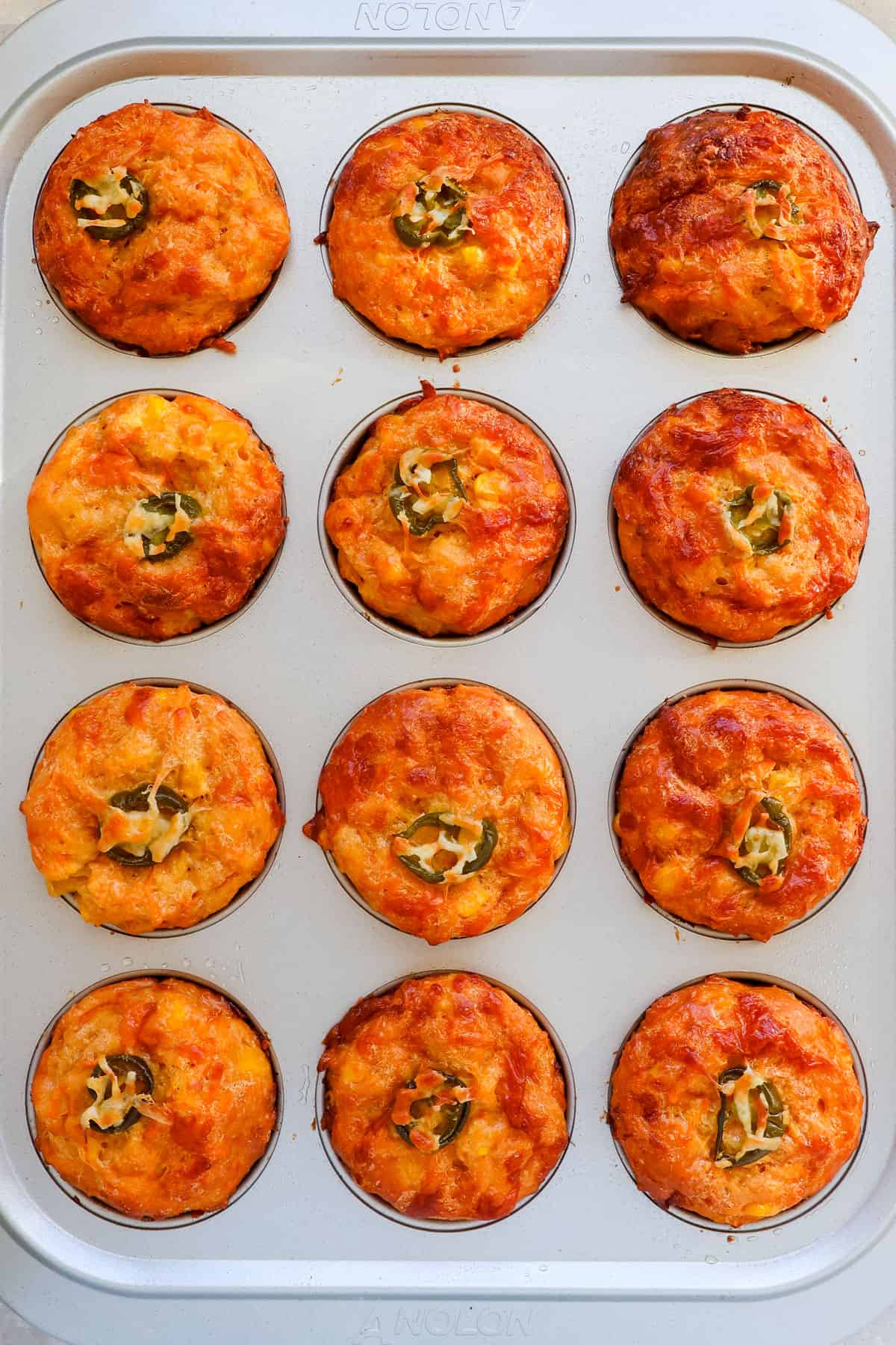 Sweet potato and corn muffins in a pan.
