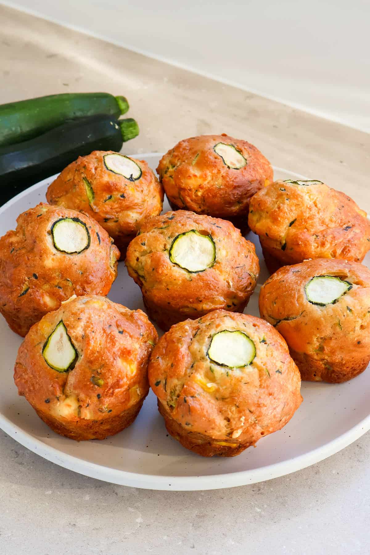 Zucchini feta muffins on a plate.
