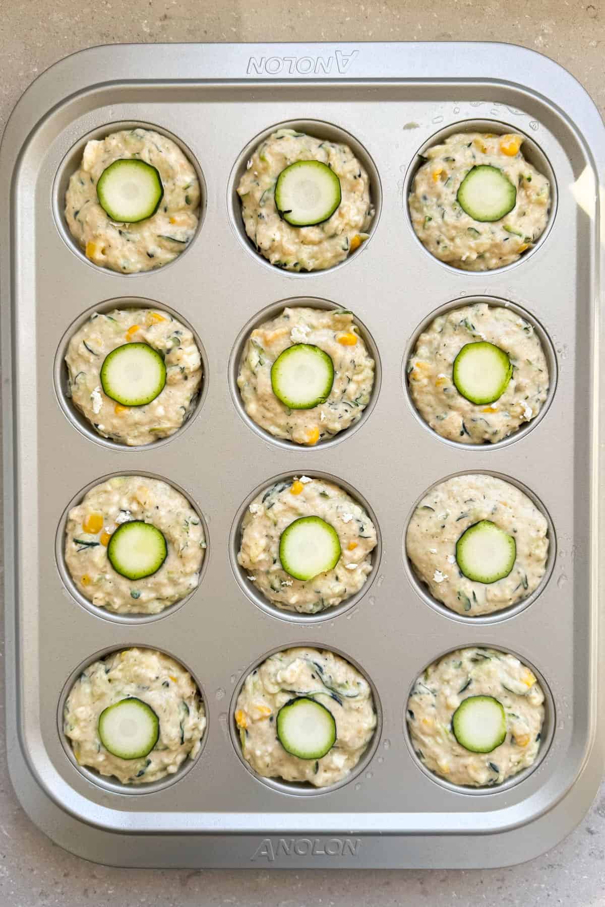 Batter added to a muffin pan.