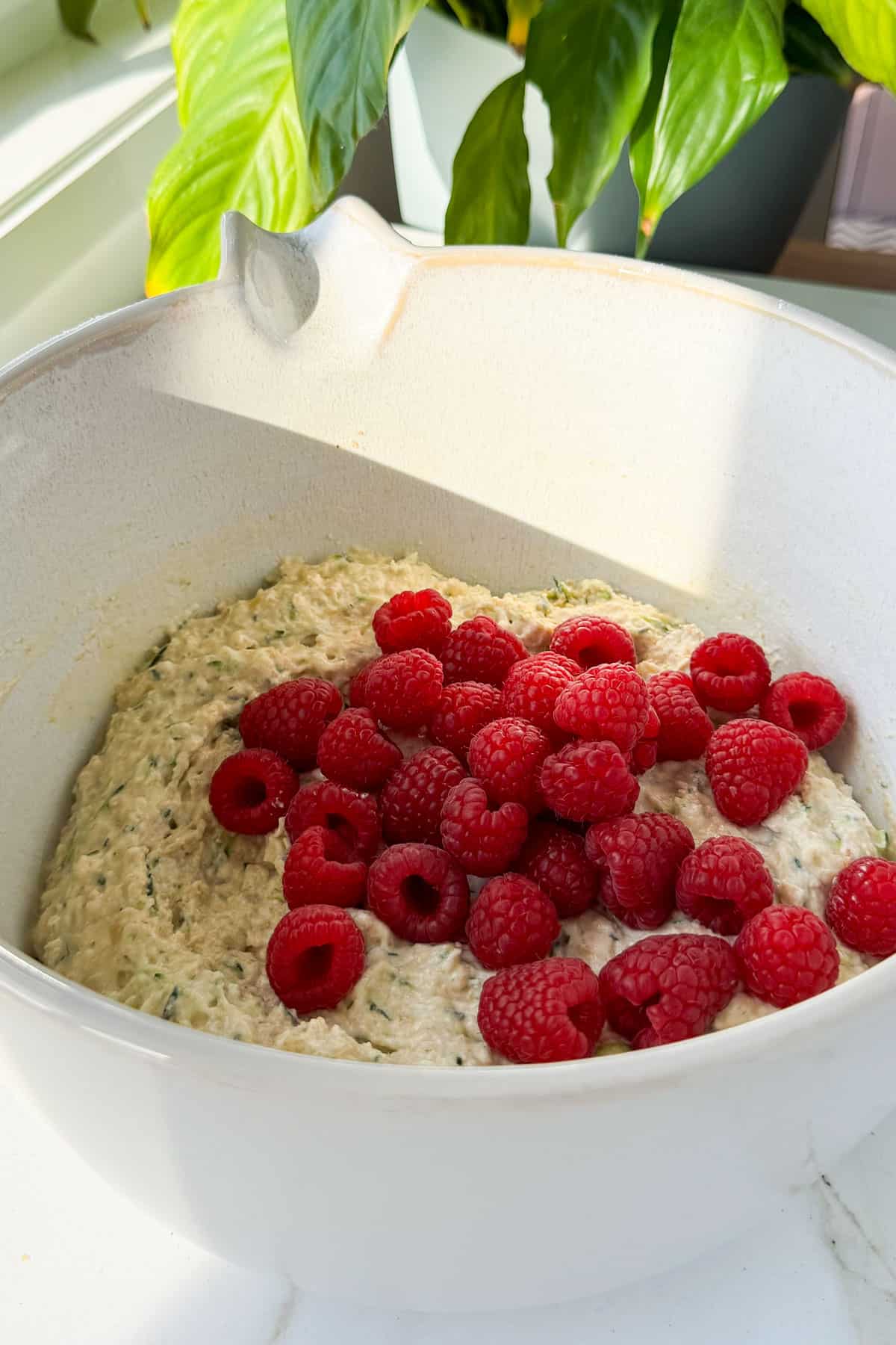 Raspberries added to the mixing bowl.
