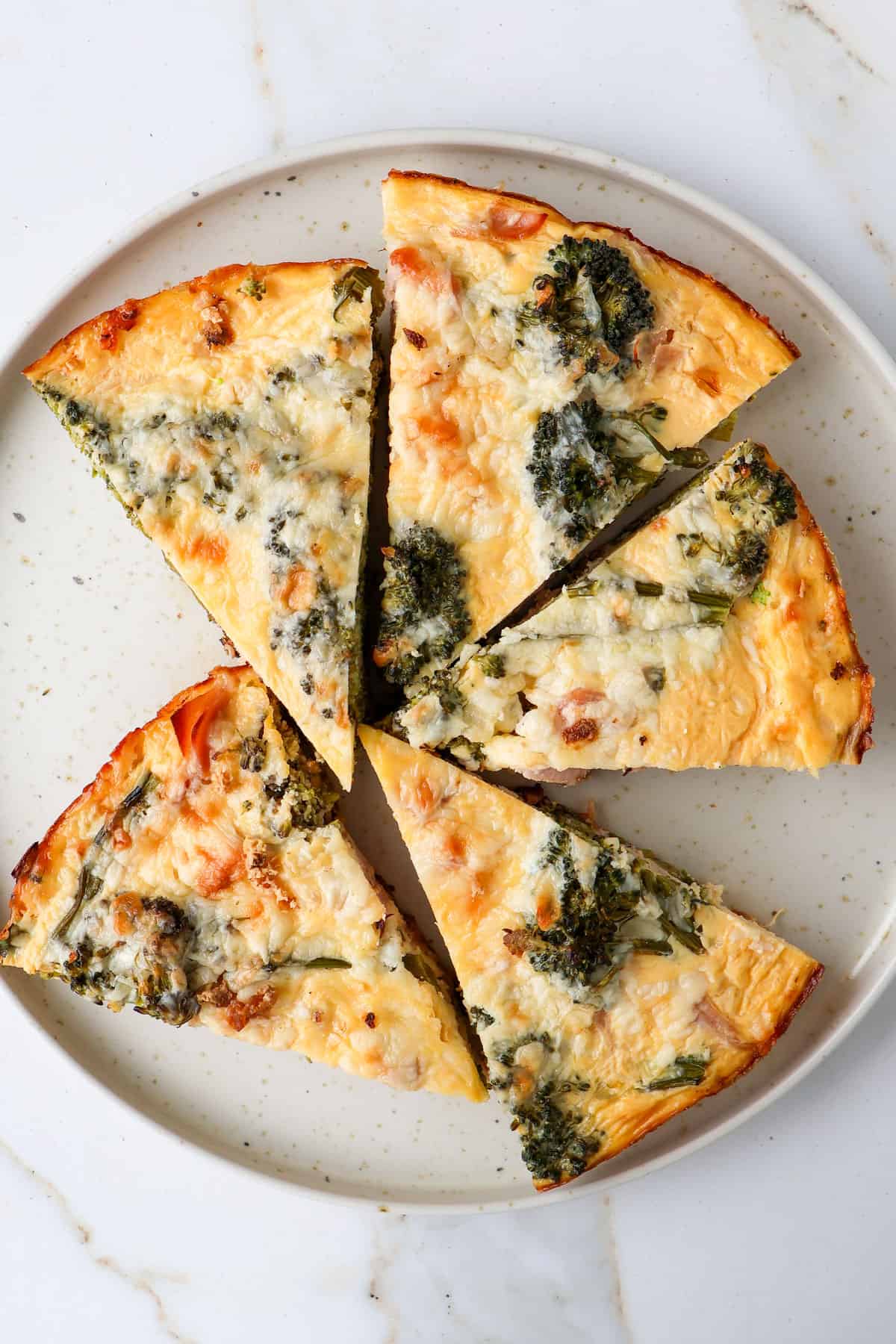 Broccolini frittata slices on a plate.