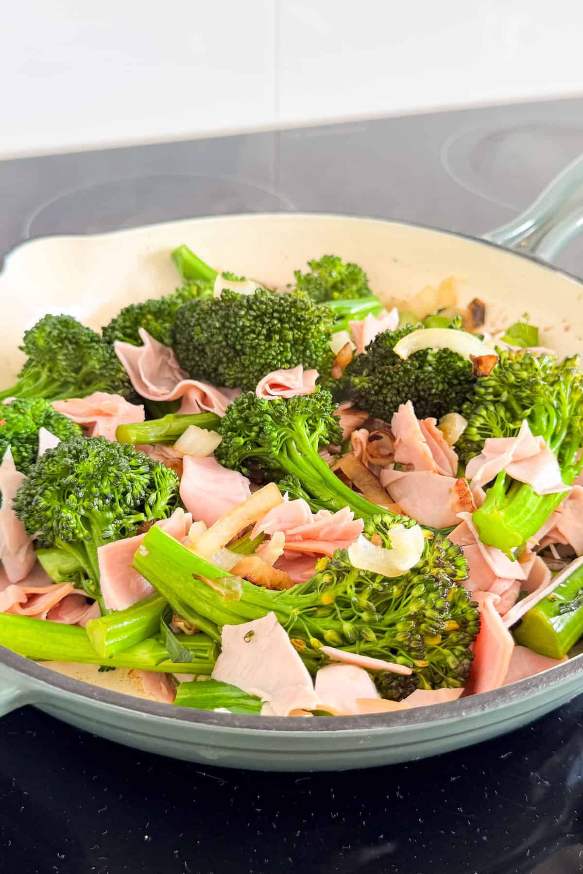 Ham added to the pan.