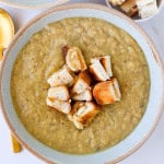 Cauliflower potato leek soup in a bowl with cut up grilled cheese toastie.