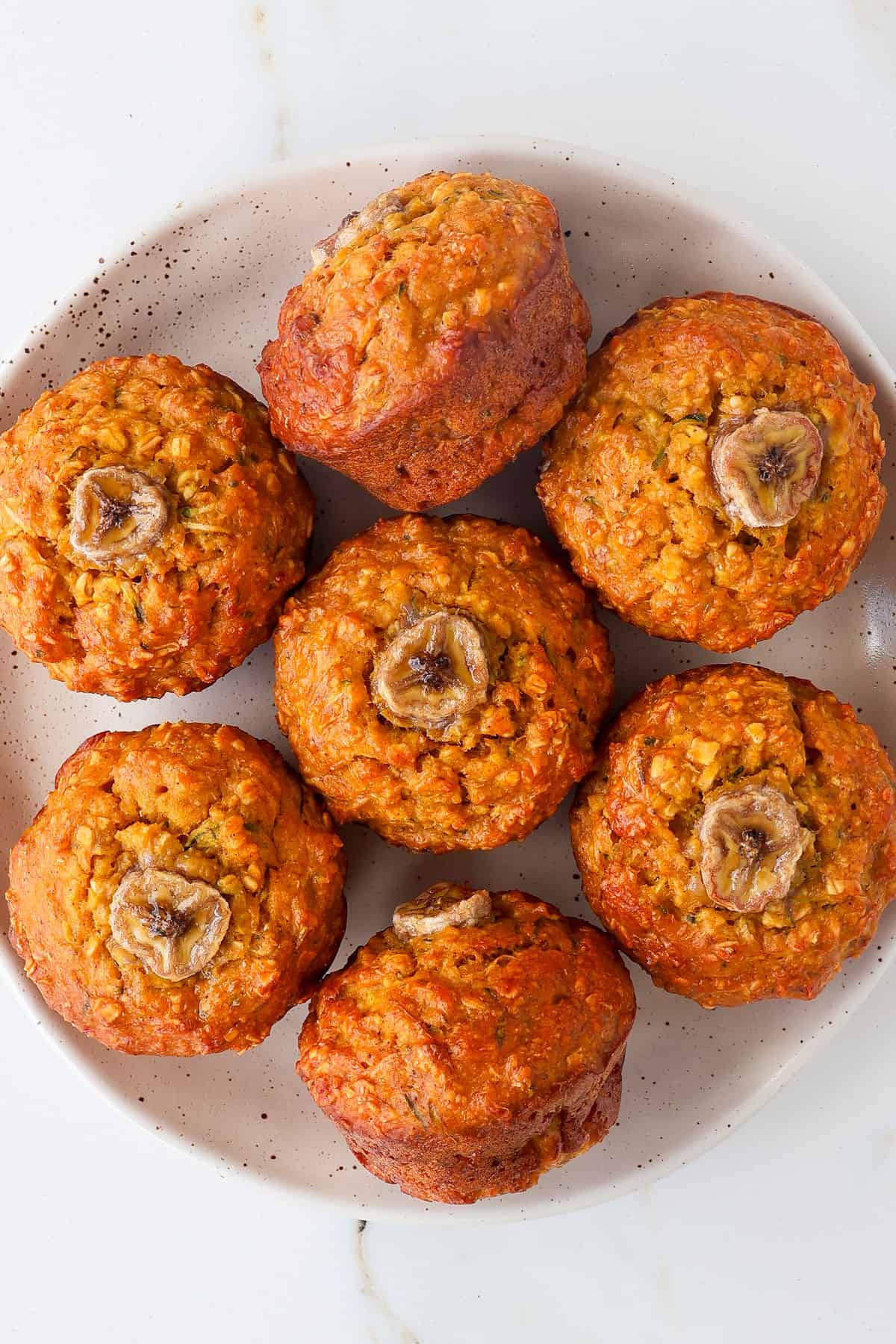 Pumpkin and banana muffins on a plate.