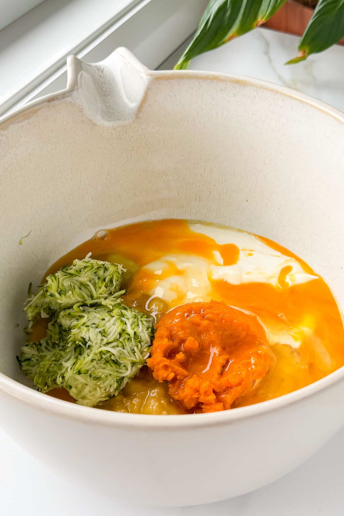 Wet ingredients being mixed in a bowl.