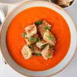 Soup in bowls with grilled cheese croutons.