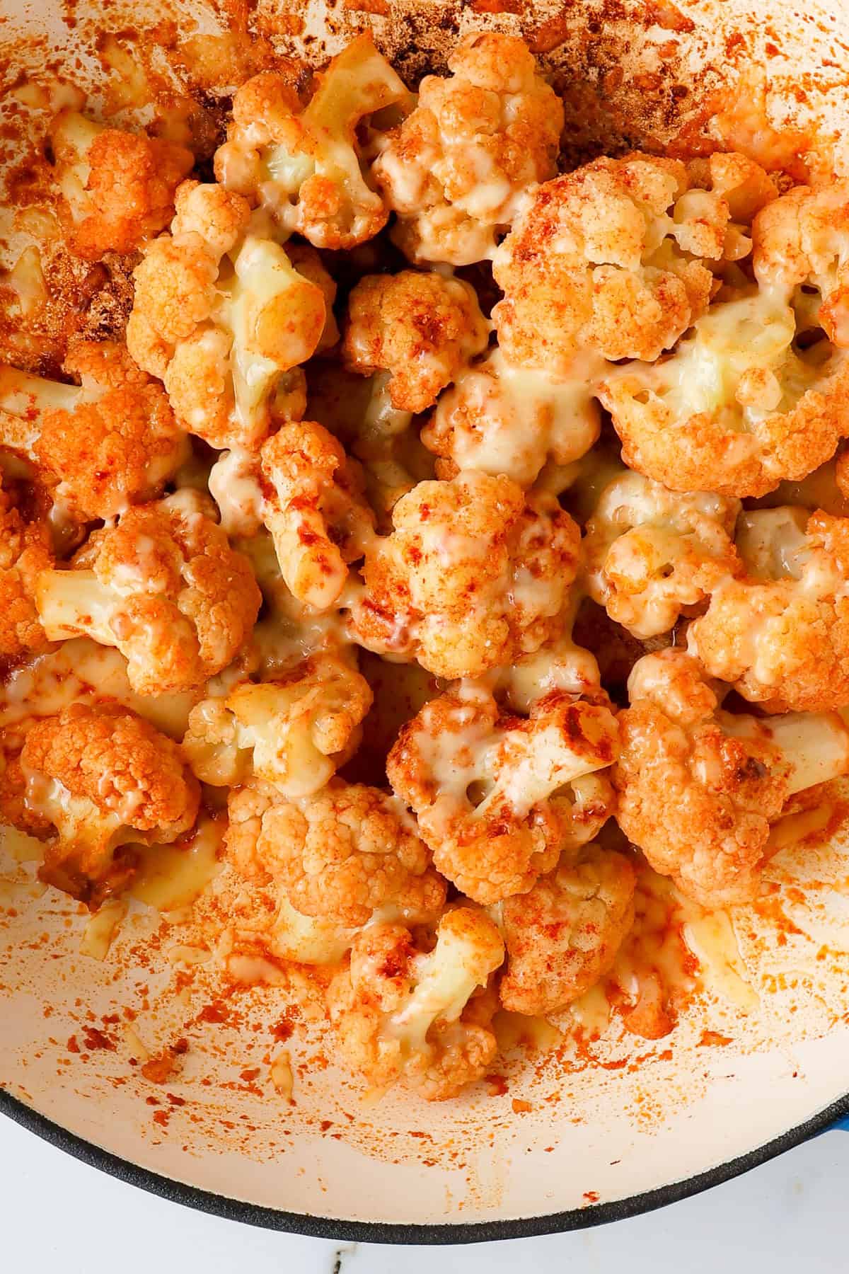 Close up of the cheesy cauliflower in a pan.