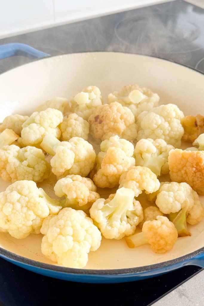 Cauliflower steaming in the pan.