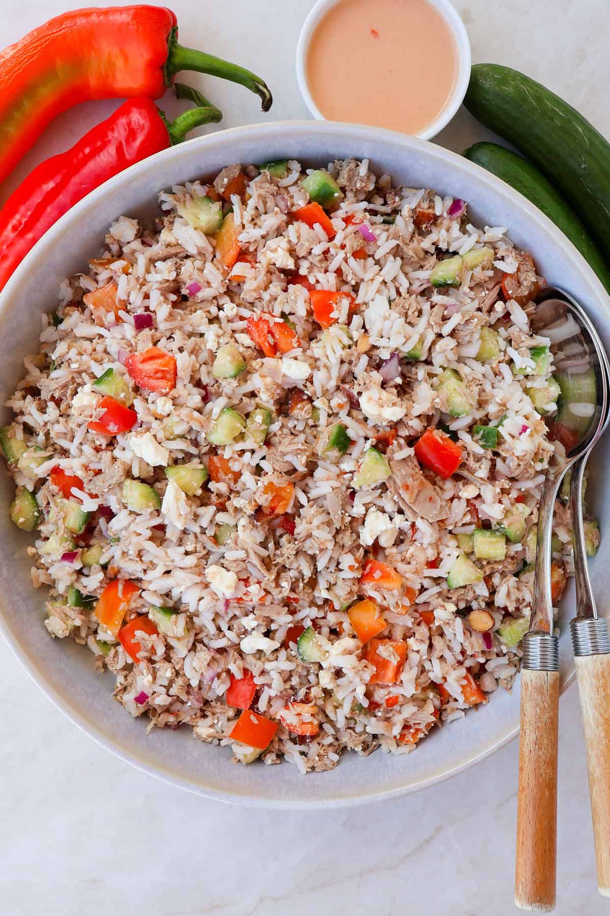 Tuna rice salad in a bowl with spoons.