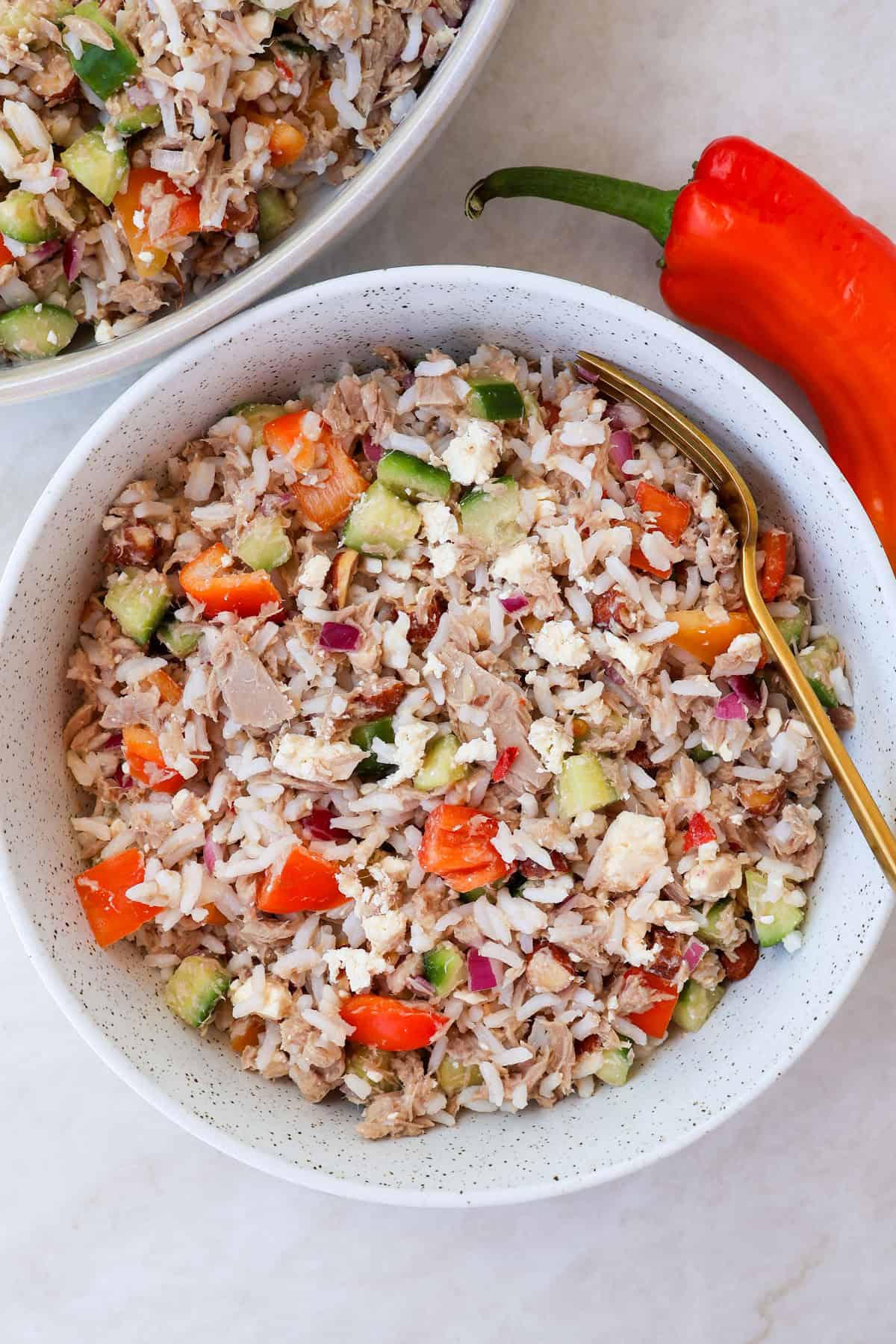 Tuna rice salad served in a bowl with a fork.